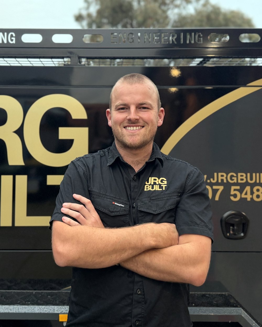 Joel, director of JRG Built, in front of the JRG Built work ute